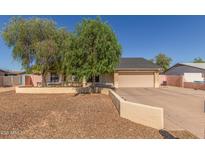 Charming single-story home with a two-car garage, neutral colors, and mature landscaping at 19407 N 15Th Ave, Phoenix, AZ 85027