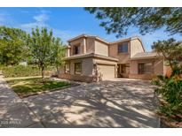 Attractive home with a spacious driveway, landscaped yard, and mature trees at 2109 W Wildhorse Dr, Chandler, AZ 85286