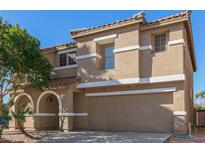 Inviting two-story home features a neutral stucco exterior, arched entry, and convenient two-car garage at 3064 E Michelle Way, Gilbert, AZ 85234