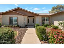 Charming single-story home featuring a well-maintained front yard with mature landscaping and a welcoming entrance at 3227 W Kristal Way, Phoenix, AZ 85027