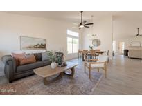 Bright living room and dining area with neutral tones, open layout, and wood-look floors offer an inviting space at 4037 E Milton Dr, Cave Creek, AZ 85331