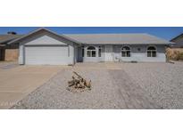 Charming single-story home featuring a two-car garage and a well-manicured, desert-landscaped front yard at 742 S Rose --, Mesa, AZ 85204