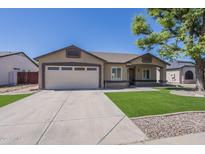 Charming single-story home with a two-car garage, manicured landscaping, and an inviting front porch at 8541 W Sierra Vista Dr, Glendale, AZ 85305