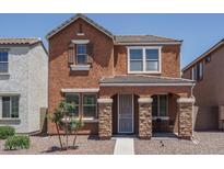 Charming two-story home with a landscaped front yard and stone accents on the entrance columns at 8964 W Northview Ave, Glendale, AZ 85305