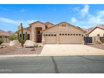 Charming single-story home with desert landscaping and a three-car garage, nestled in a sunny locale at 10214 E Moonshadow Way, Gold Canyon, AZ 85118