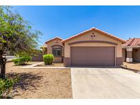 Single-story home featuring a neutral color scheme, a tile roof, and a two-car garage at 10521 W Donald Dr, Peoria, AZ 85383