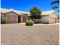 Charming single-story home featuring a desert landscaped yard and a two-car garage at 10722 W Quartz Dr, Casa Grande, AZ 85193