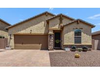 Charming single-story home with desert landscaping, a two-car garage, and covered entryway at 226 E Monza Way, San Tan Valley, AZ 85140