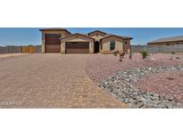 Charming single-story home with a well-manicured yard, desert landscaping, and a spacious driveway at 29408 N 224Th Dr, Wittmann, AZ 85361