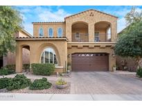 Inviting two-story home with a beautiful tan stucco exterior and a large two-car garage at 4615 E Navigator Ln, Phoenix, AZ 85050