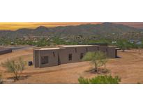 Desert home featuring stucco exterior, mountain views, and drought-tolerant landscaping at 553 W Cavalry Rd, New River, AZ 85087