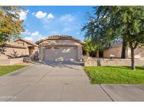 Charming single story home with a two car garage, large driveway and well-maintained lawn at 5734 W Commonwealth Pl, Chandler, AZ 85226