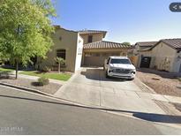 Charming home with a two-car garage and well-manicured front yard at 13687 N 151St Ln, Surprise, AZ 85379