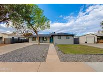 Charming gray single-story home with manicured landscaping and a welcoming blue front door at 1530 W Glenrosa Ave, Phoenix, AZ 85015