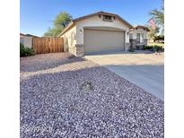 Charming single-story home with a two-car garage and low maintenance desert landscaping at 16176 W Lisbon Ln, Surprise, AZ 85379
