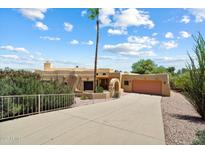 Beautiful home featuring a long drive, desert landscaping and an attached garage at 16927 E Trojan Ct, Fountain Hills, AZ 85268