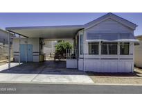 Charming mobile home exterior showcasing a covered parking area and a well-maintained front entrance at 17200 W Bell Rd # 812, Surprise, AZ 85374