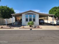 Charming home showcasing a covered carport and well-kept landscaping on a sunny day at 18026 N Cave Creek Rd # 16, Phoenix, AZ 85032
