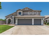 Charming two-story home featuring a three-car garage and tile roof at 1847 W Leah Ln, Gilbert, AZ 85233