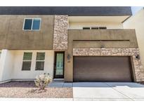 Contemporary two-story home featuring stone accents, a dark roof, and an integrated two-car garage at 2000 N 36Th St # 17, Phoenix, AZ 85008