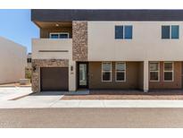 Modern townhome featuring stacked stone accents, a garage, and neutral color scheme at 2000 N 36Th St # 20, Phoenix, AZ 85008