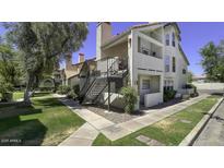 Inviting condo exterior showcasing staircase access and manicured landscaping at 2333 E Southern Ave # 1015, Tempe, AZ 85282