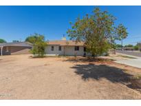 Single story home featuring a front yard with mature trees and a gravel landscape at 3302 W Turney Ave, Phoenix, AZ 85017