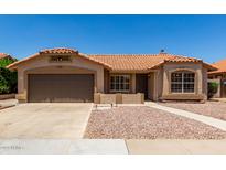 Single story home featuring a brown two car garage, tile roof, desert landscaping, and sidewalk leading to the front door at 4336 E Aspen Ave, Mesa, AZ 85201