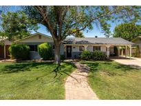 Charming single-story home featuring mature shade tree and covered carport, offering curb appeal and functionality at 5438 E Avalon Dr, Phoenix, AZ 85018