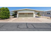 Charming single-story home with a carport, desert landscaping, and a cozy, inviting facade at 6960 W Peoria Ave # 74, Peoria, AZ 85345