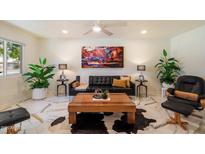 Bright living room featuring modern decor, marble floors, and stylish furniture at 10305 W Campana Dr, Sun City, AZ 85351