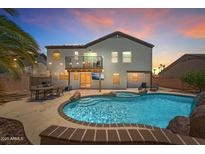 Backyard features a beautiful pool, spa, dining, and balcony, perfect for entertaining at 13626 N 89Th St, Scottsdale, AZ 85260