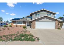 Charming two-story home features a two-car garage, solar panels and a low maintenance front yard at 15410 N 60Th Ave, Glendale, AZ 85306