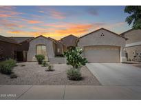 Charming single-story home featuring a desert landscape, tiled roof, and neutral stucco facade at 16368 W Cortez St, Surprise, AZ 85388