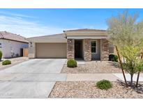 Charming single-story home with stone accents, low maintenance front yard, and two-car garage at 18854 W Poinsettia Dr, Surprise, AZ 85388