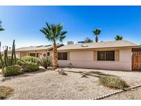 Charming home with desert landscaping, including palm trees and cacti, offering curb appeal at 2018 W Taro Ln, Phoenix, AZ 85027