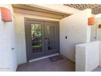 Inviting entryway with double doors, textured walls, and a welcome mat, offering a warm entrance to the home at 2333 E Southern Ave # 2033, Tempe, AZ 85282