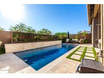 Stunning pool with a desert mountain-themed water feature at 23448 N 76Th Pl, Scottsdale, AZ 85255