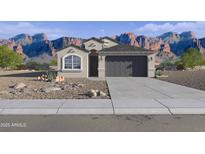 Charming single-story home boasts a desert landscape and grey two car garage against a mountain backdrop at 24222 W Hacienda Ave, Buckeye, AZ 85326
