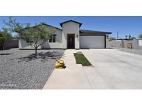 Charming single-story home with a low-maintenance landscaped yard, complemented by a modern, attached two-car garage at 2790 W Cholla St, Apache Junction, AZ 85120