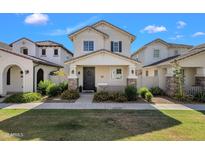 Charming two-story home featuring a welcoming front porch with stone accents and manicured landscaping at 3863 S Posse Trl, Gilbert, AZ 85297