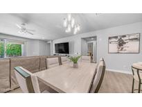 Bright dining area featuring a chandelier, table with seating, and an open concept living space at 4341 W Pelotazo Way, San Tan Valley, AZ 85144