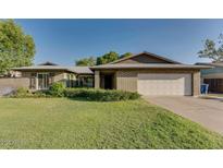 Charming single-story brick home with well-maintained landscaping and a spacious two-car garage at 717 W Manhatton Dr, Tempe, AZ 85282