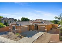 Charming single-story home boasts desert landscaping, tile roof, and multiple car garage at 1506 E Branham Ln, Phoenix, AZ 85042