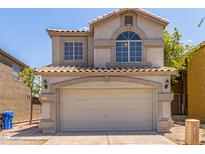 Charming two-story home featuring a two-car garage and well-maintained front yard in a residential neighborhood at 1515 E South Fork Dr, Phoenix, AZ 85048
