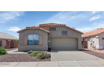 Charming single-story home with a well-maintained front yard and a two-car garage, showcasing classic curb appeal at 18089 W Weatherby Dr, Surprise, AZ 85374