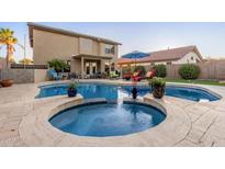 Relaxing backyard pool and spa with lounge chairs, a covered patio, and lush landscaping, perfect for outdoor entertaining at 3031 S Cortland --, Mesa, AZ 85212