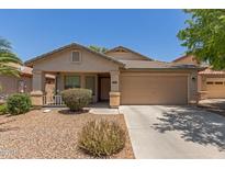 Charming single-story home with a well-maintained front yard and a two-car garage at 41280 W Sanders Way, Maricopa, AZ 85138