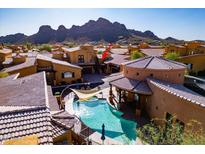 Stunning aerial view of backyard pool, community homes and mountain views in a desert setting at 5370 S Desert Dawn Dr # 56, Gold Canyon, AZ 85118