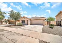 Charming single-story home with a well-maintained front yard and a spacious two-car garage at 597 S 167Th Dr, Goodyear, AZ 85338